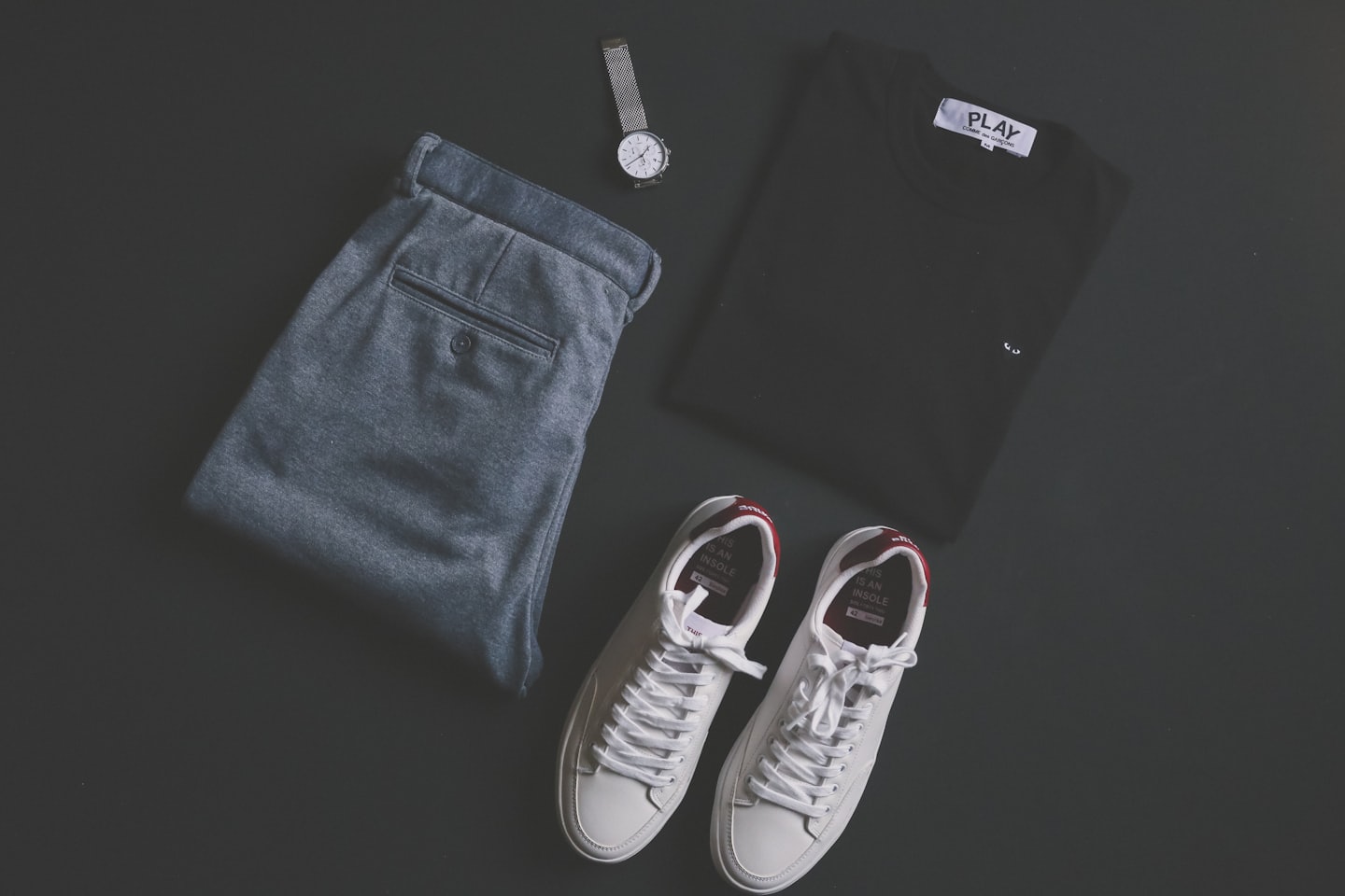 Men's casual outfit with trousers, shirt, watch, and sneakers.